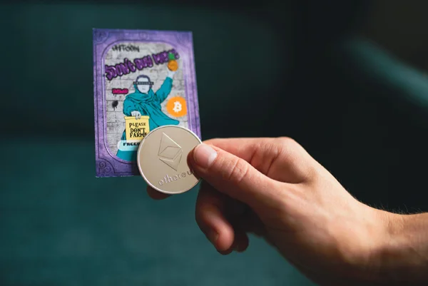 A hand holding an etherium coin