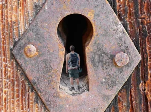 A keyhole with a person inside it representing the use of passkeys to protect data